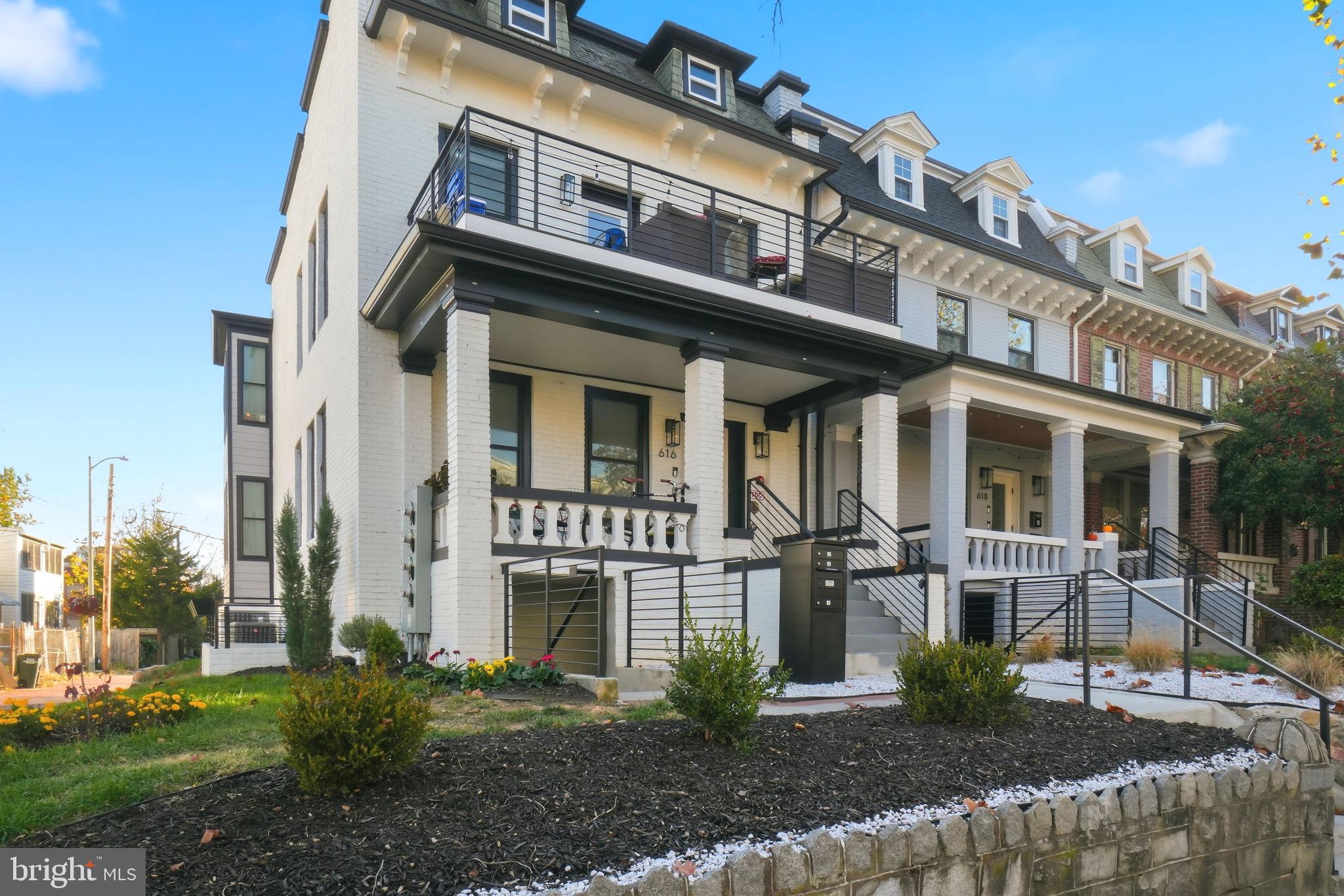 616 Quebec Place Northwest, Unit 1 Washington, DC 20010 - Photo 22 of 26 a front view of a residential apartment building with a yard