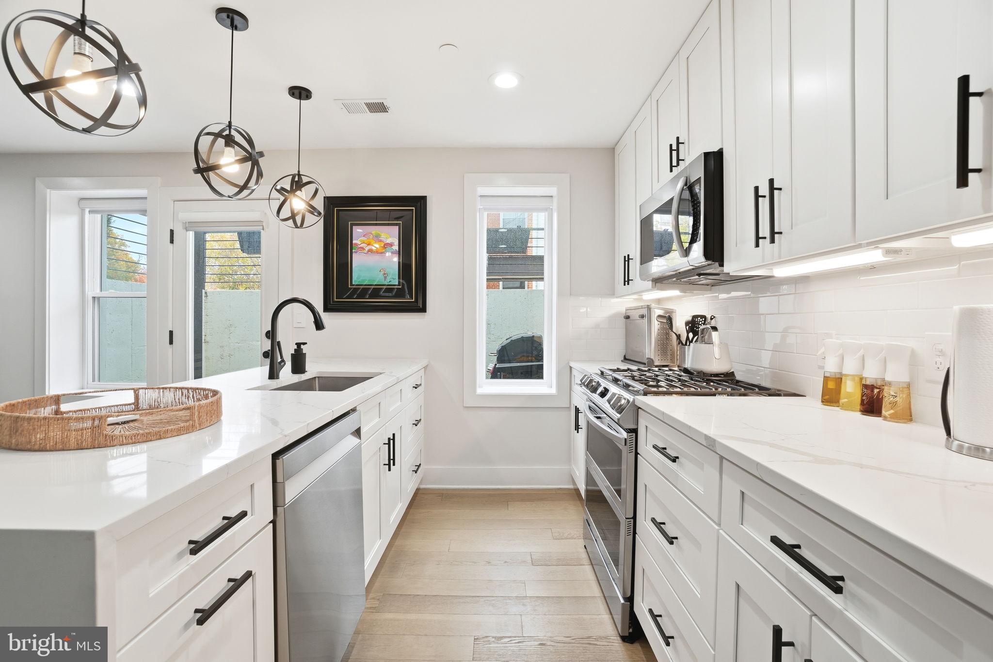 616 Quebec Place Northwest, Unit 1 Washington, DC 20010 - Photo 7 of 26 a kitchen with cabinets and window