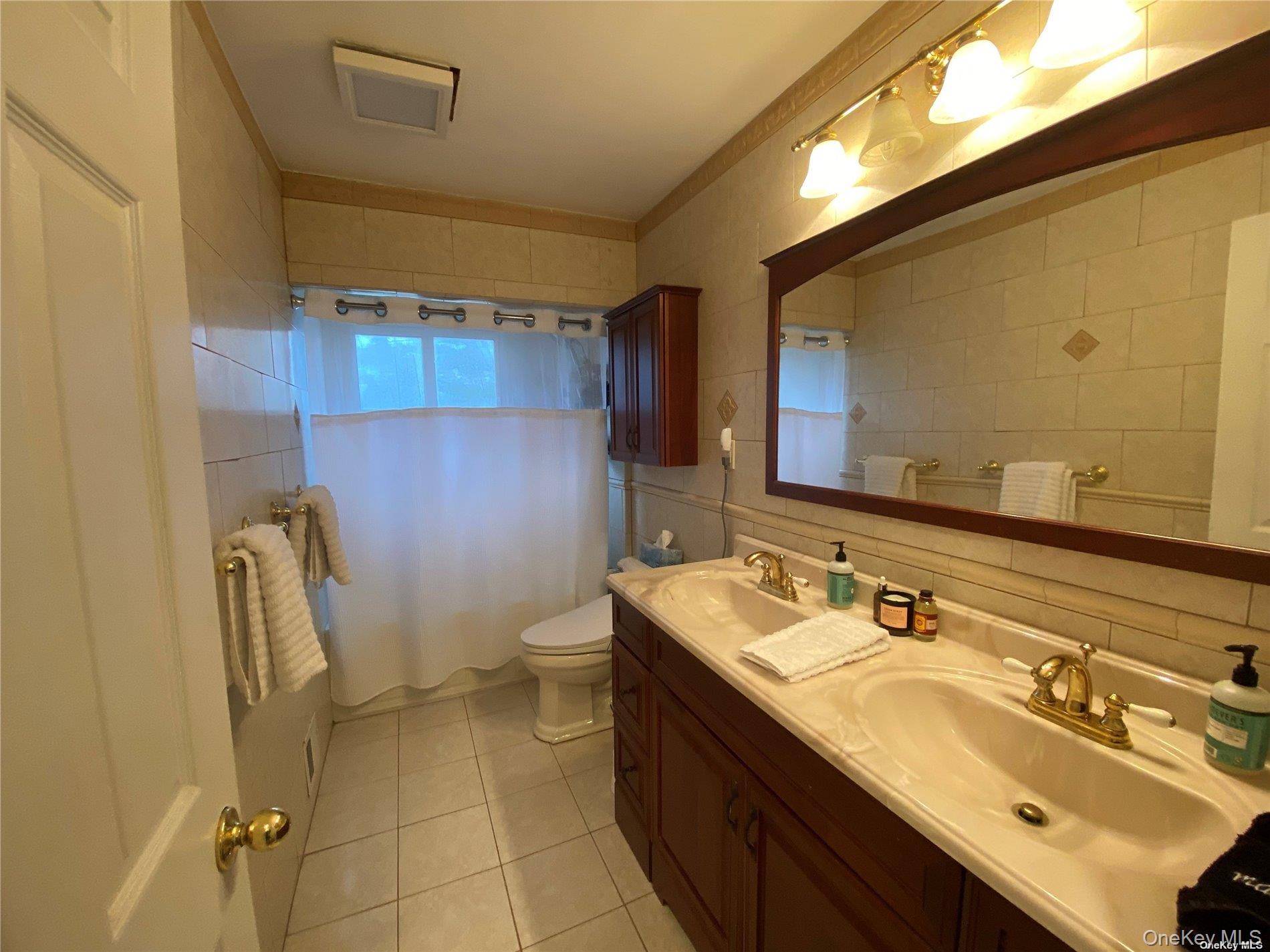 23 Duncan Lane Huntington, NY 11743 - Photo 11 of 25 a bathroom with a sink and a mirror