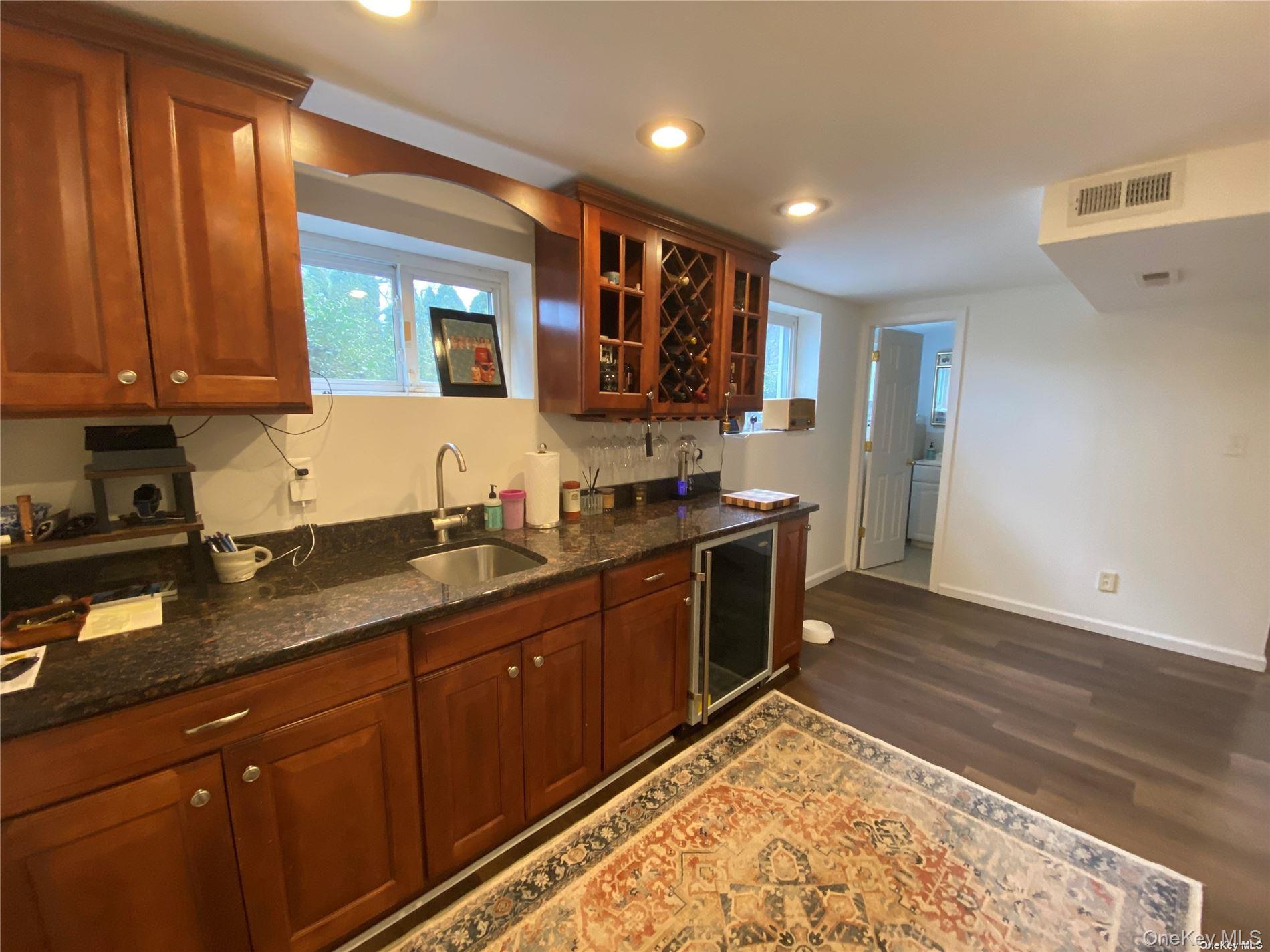 23 Duncan Lane Huntington, NY 11743 - Photo 12 of 25 a kitchen with stainless steel appliances granite countertop a sink stove and cabinets
