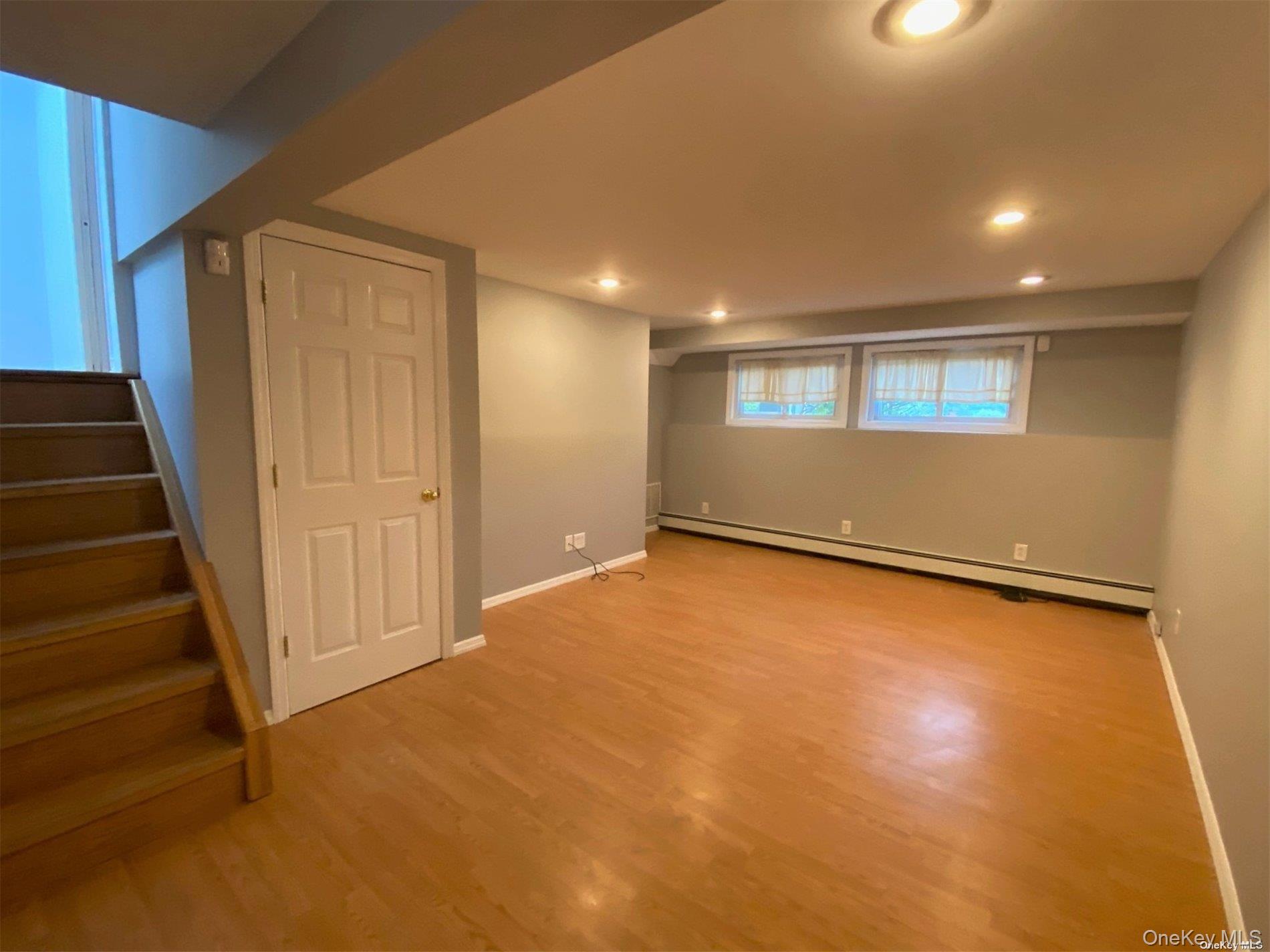 23 Duncan Lane Huntington, NY 11743 - Photo 15 of 25 a view of an empty room with wooden floor and a window