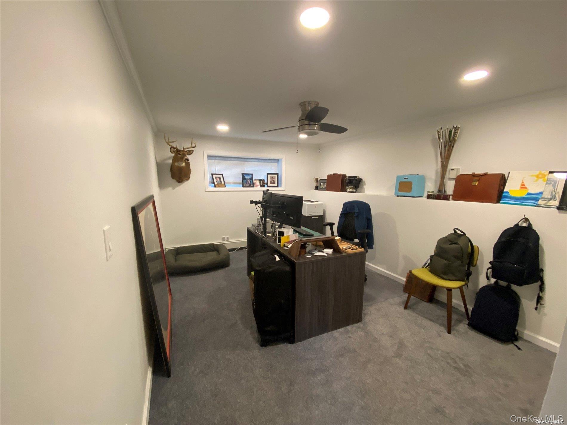 23 Duncan Lane Huntington, NY 11743 - Photo 17 of 25 a living room with furniture and a flat screen tv