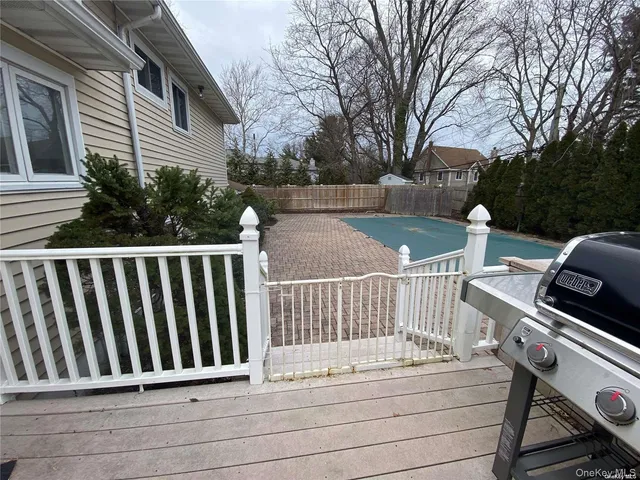 a view of balcony with wooden floor and fence