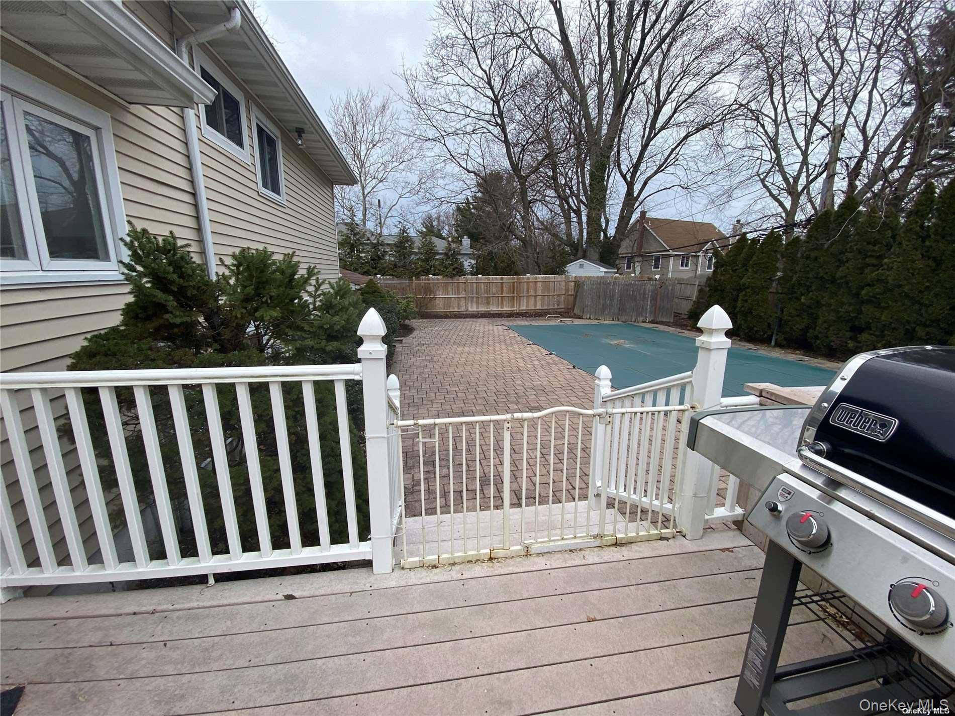 23 Duncan Lane Huntington, NY 11743 - Photo 22 of 25 a view of balcony with wooden floor and fence