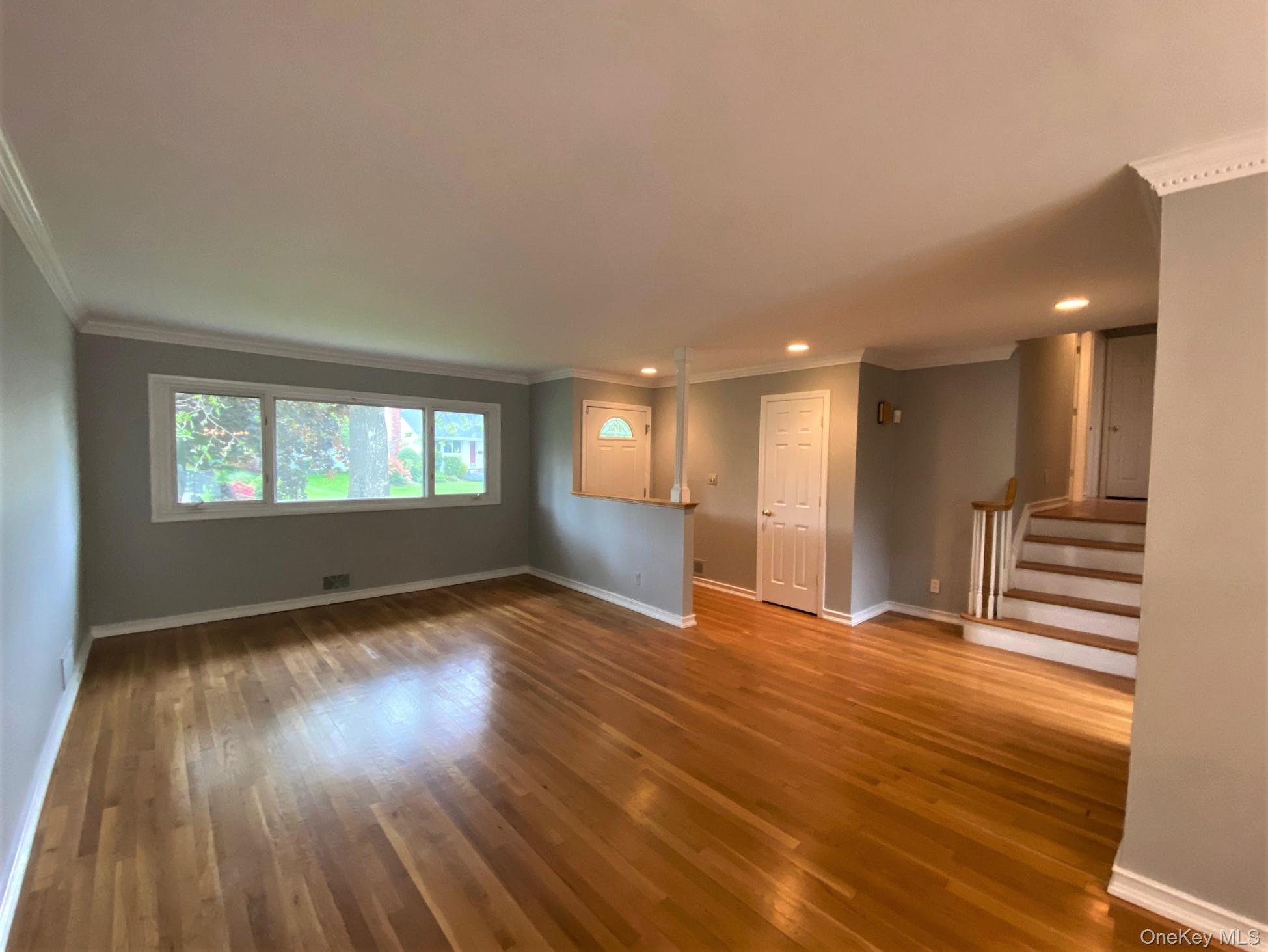 23 Duncan Lane Huntington, NY 11743 - Photo 4 of 25 a view of an empty room with wooden floor and a window