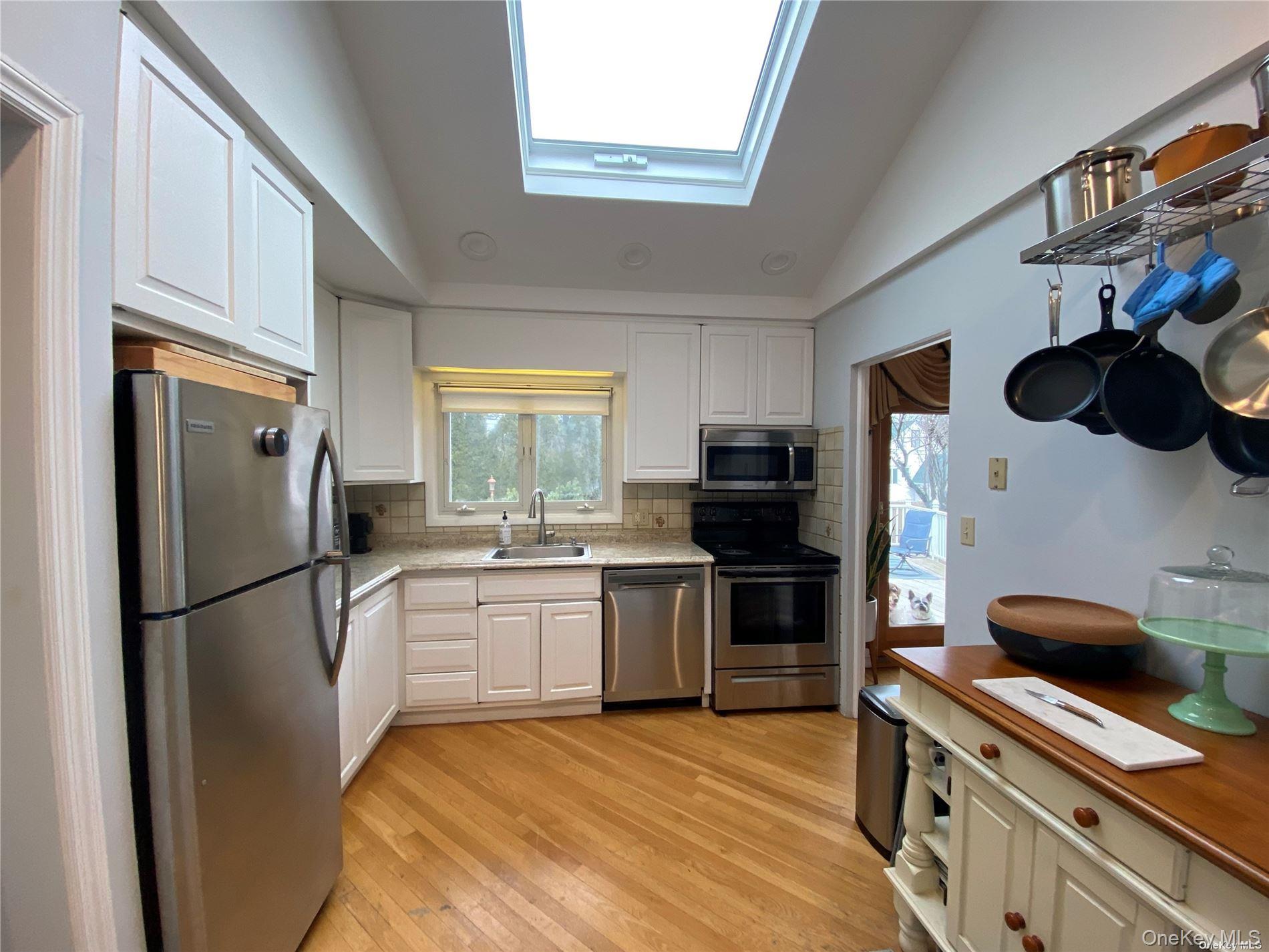 23 Duncan Lane Huntington, NY 11743 - Photo 8 of 25 a kitchen with a refrigerator and a sink