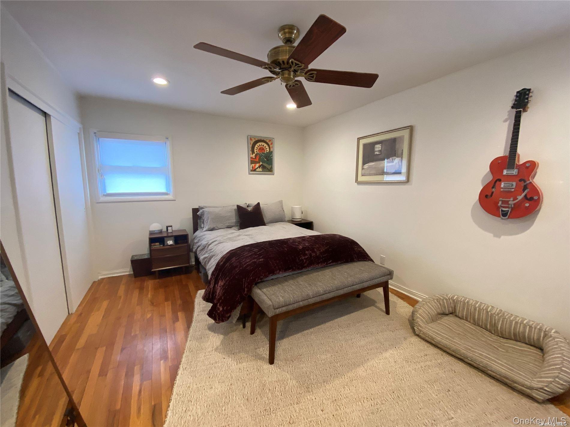 23 Duncan Lane Huntington, NY 11743 - Photo 9 of 25 a bedroom with a bed and a couch