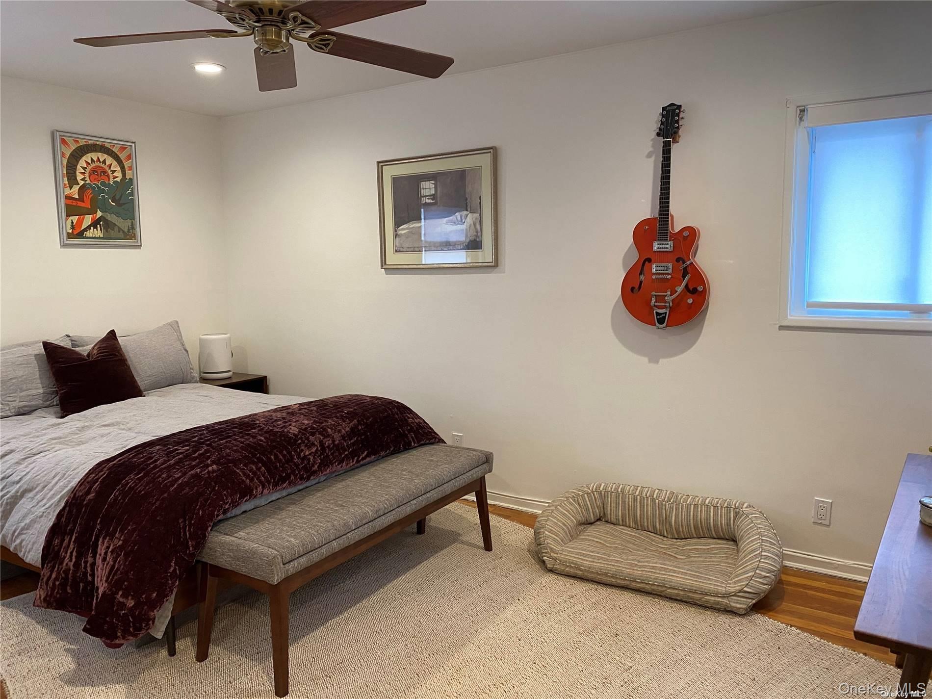 23 Duncan Lane Huntington, NY 11743 - Photo 10 of 25 a bedroom with a bed and a chandelier