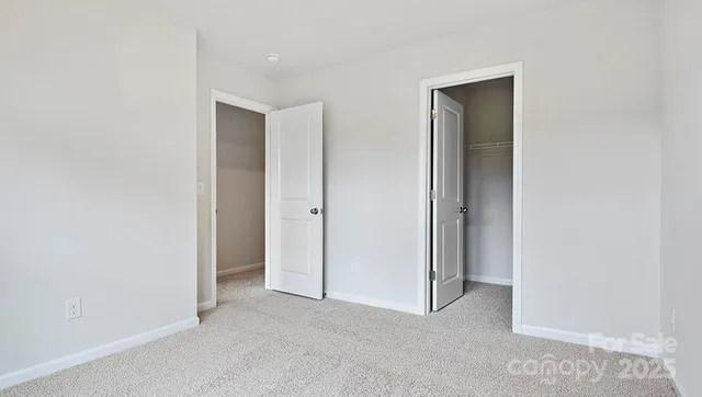 a view of an empty room and closet area
