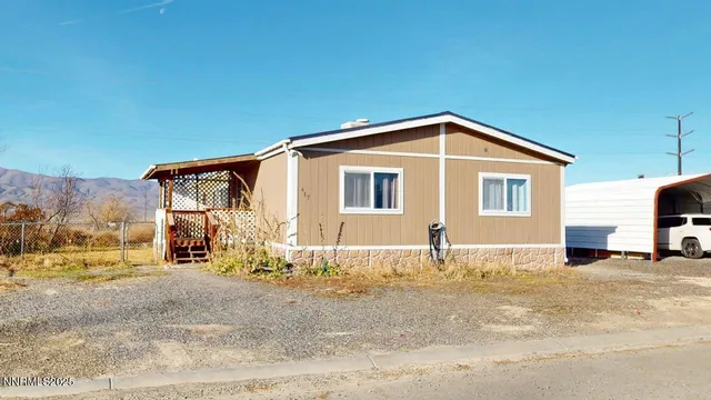 a view of a house with snow on the road