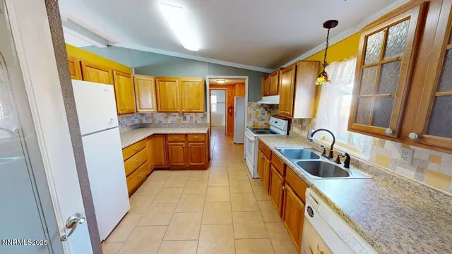 a kitchen with a sink a counter top space cabinets and a large window