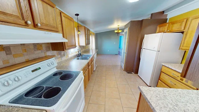 a kitchen with a stove a sink and a refrigerator