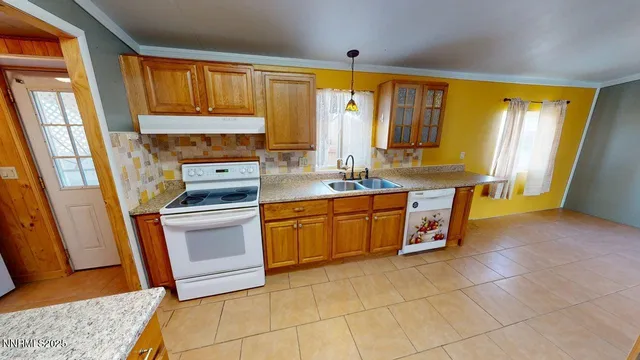 a kitchen with stainless steel appliances a stove a sink and a refrigerator