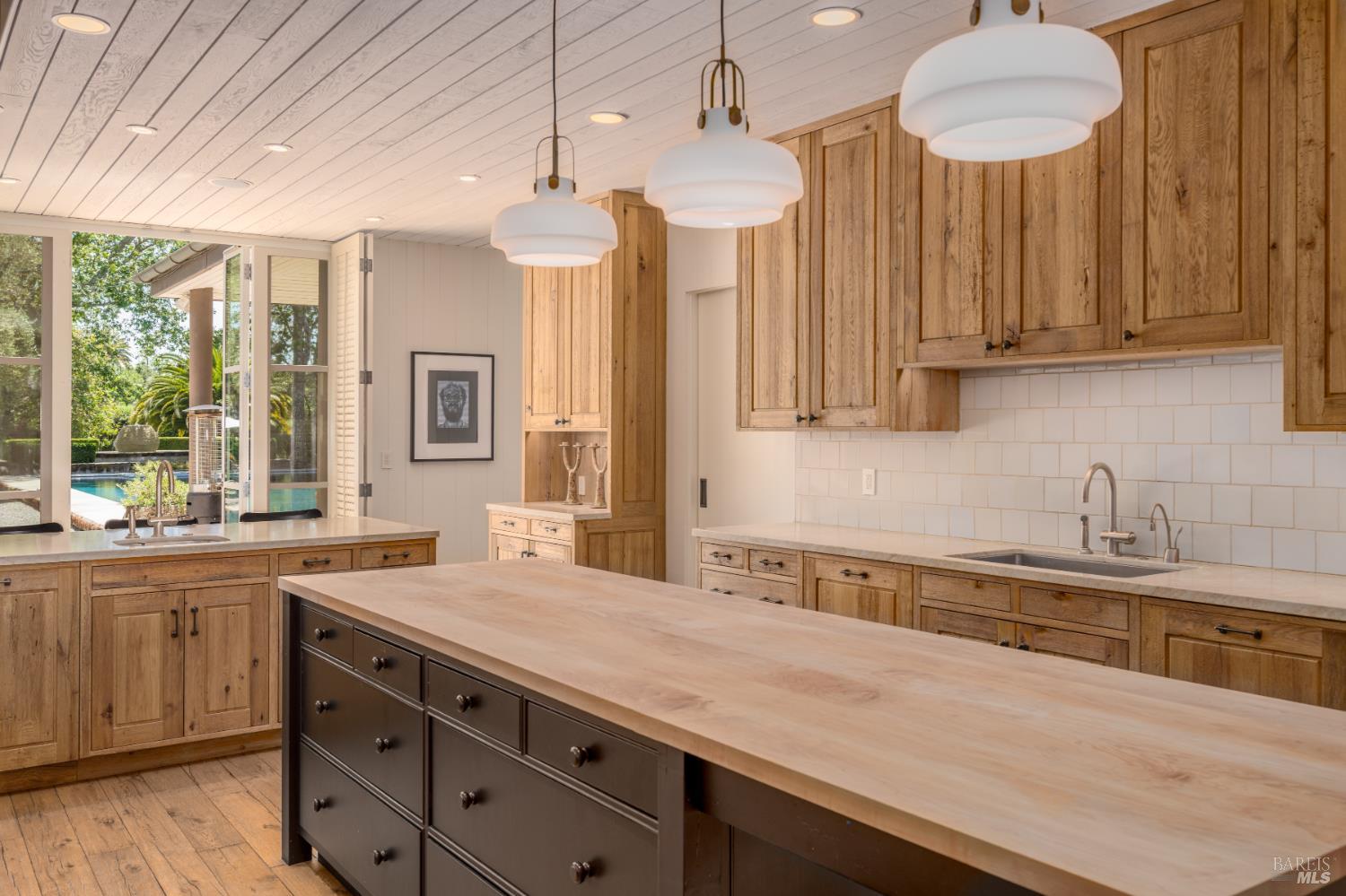 900 Rutherford Road St. Helena, CA 94574 - Photo 14 of 70 a kitchen with granite countertop a sink a counter space appliances and cabinets