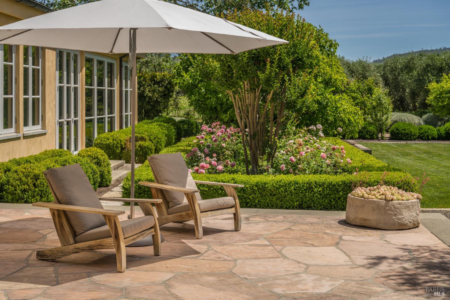 900 Rutherford Road St. Helena, CA 94574 - Photo 45 of 70 a view of a patio with chairs and a yard