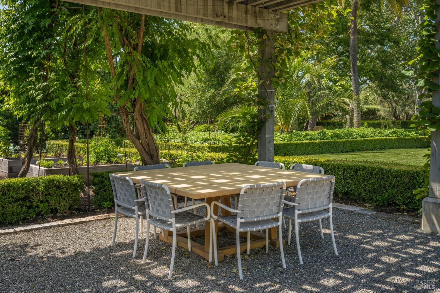 900 Rutherford Road St. Helena, CA 94574 - Photo 50 of 70 a view of a backyard with table and chairs and a couple of flower plants