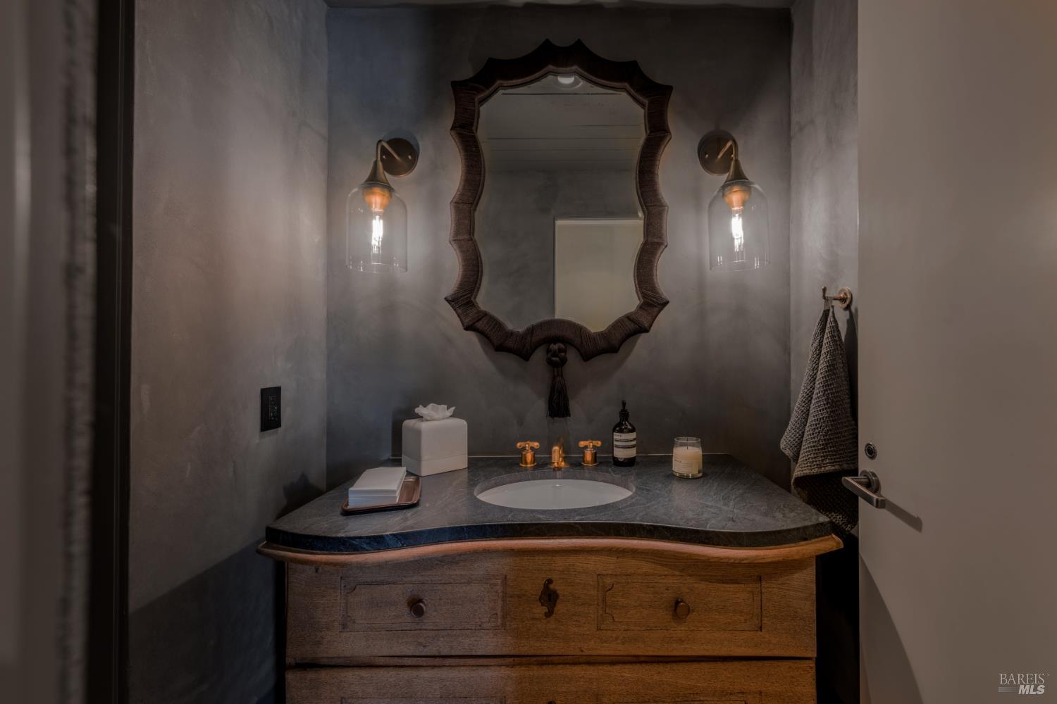 900 Rutherford Road St. Helena, CA 94574 - Photo 66 of 70 a bathroom with a sink a mirror and vanity