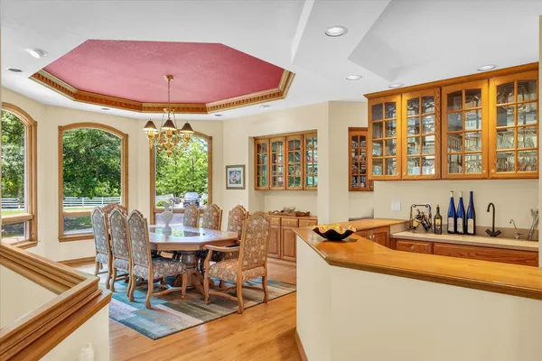 a living room with furniture floor to ceiling window and wooden floor