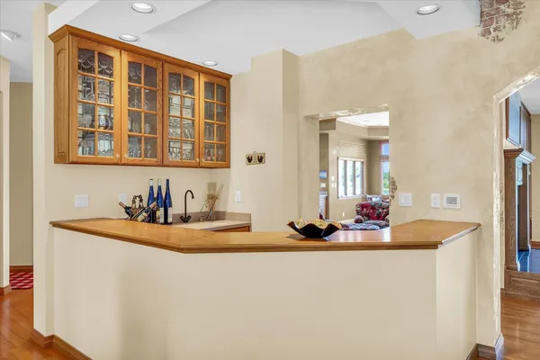 a living room with furniture pool table wooden floor and windows