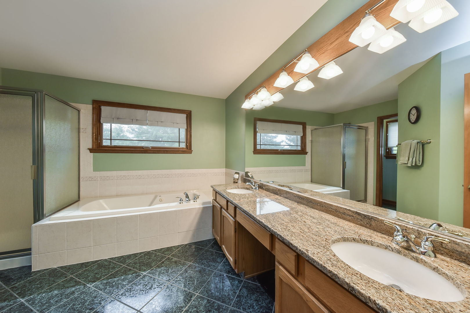 220 Aldrin Avenue Batavia, IL 60510 - Photo 13 of 23 a spacious bathroom with a granite countertop tub a double vanity sink and a large mirror