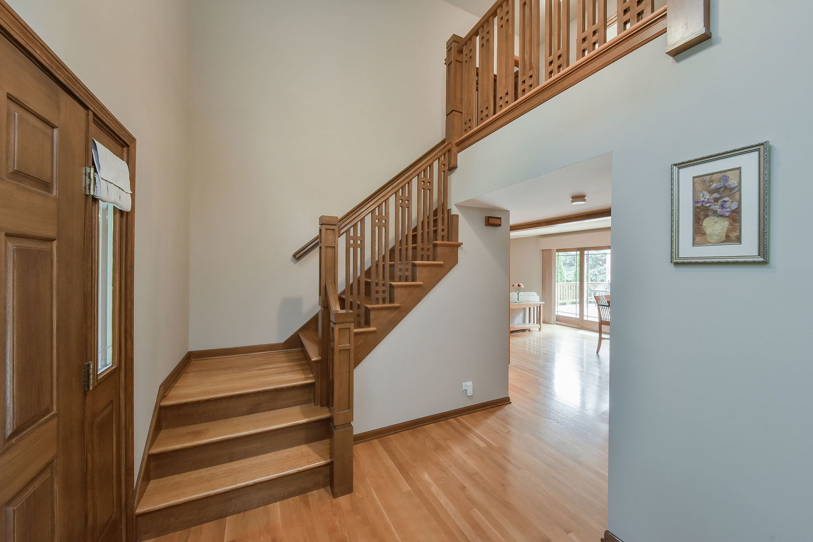 220 Aldrin Avenue Batavia, IL 60510 - Photo 2 of 23 a view of staircase with wooden floor and white walls