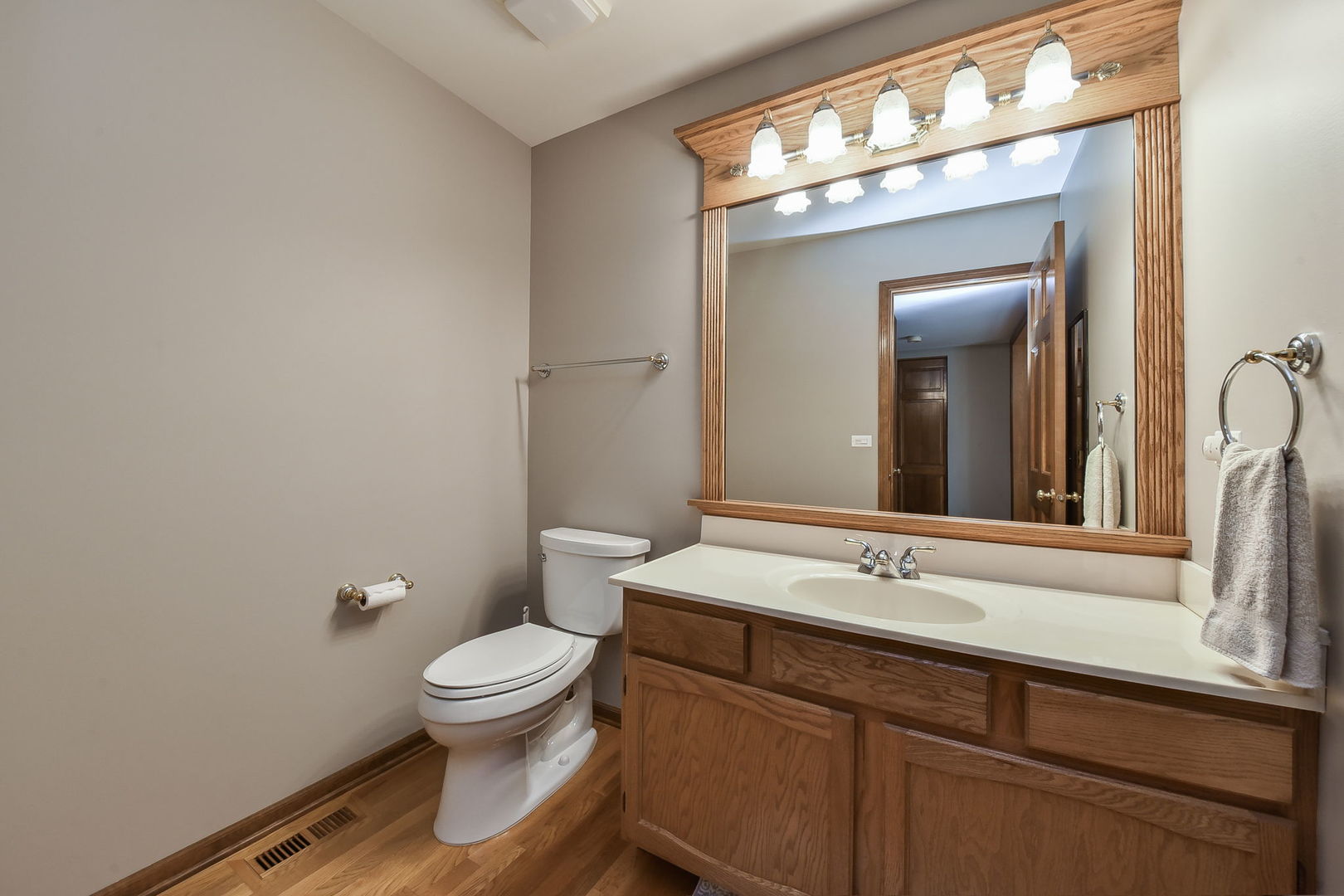 220 Aldrin Avenue Batavia, IL 60510 - Photo 10 of 23 a bathroom with a toilet a sink and mirror