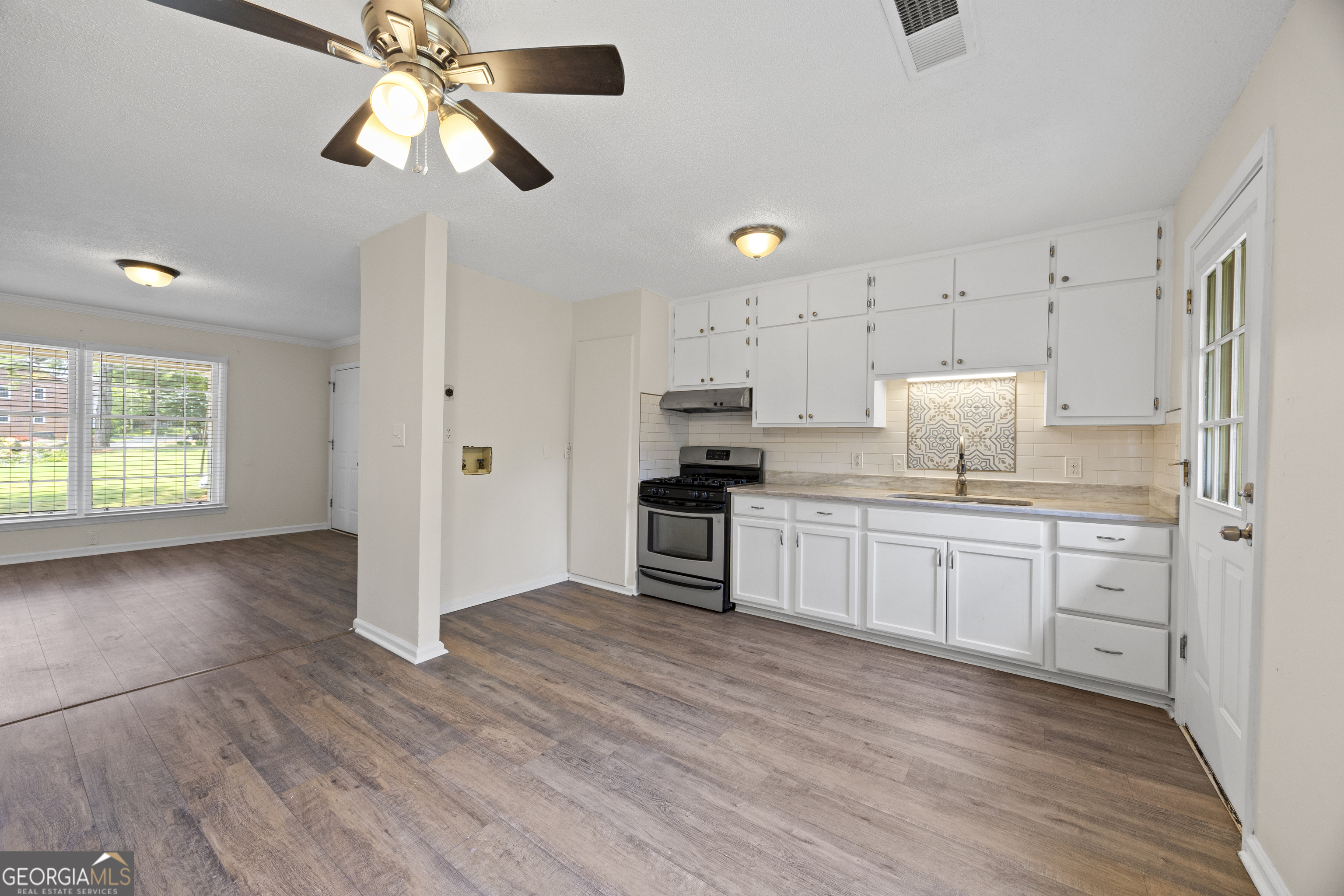 135 Hill Street, Unit 22 Decatur, GA 30030 - Photo 13 of 36 a kitchen with a refrigerator a stove top oven a sink and dishwasher with wooden floor