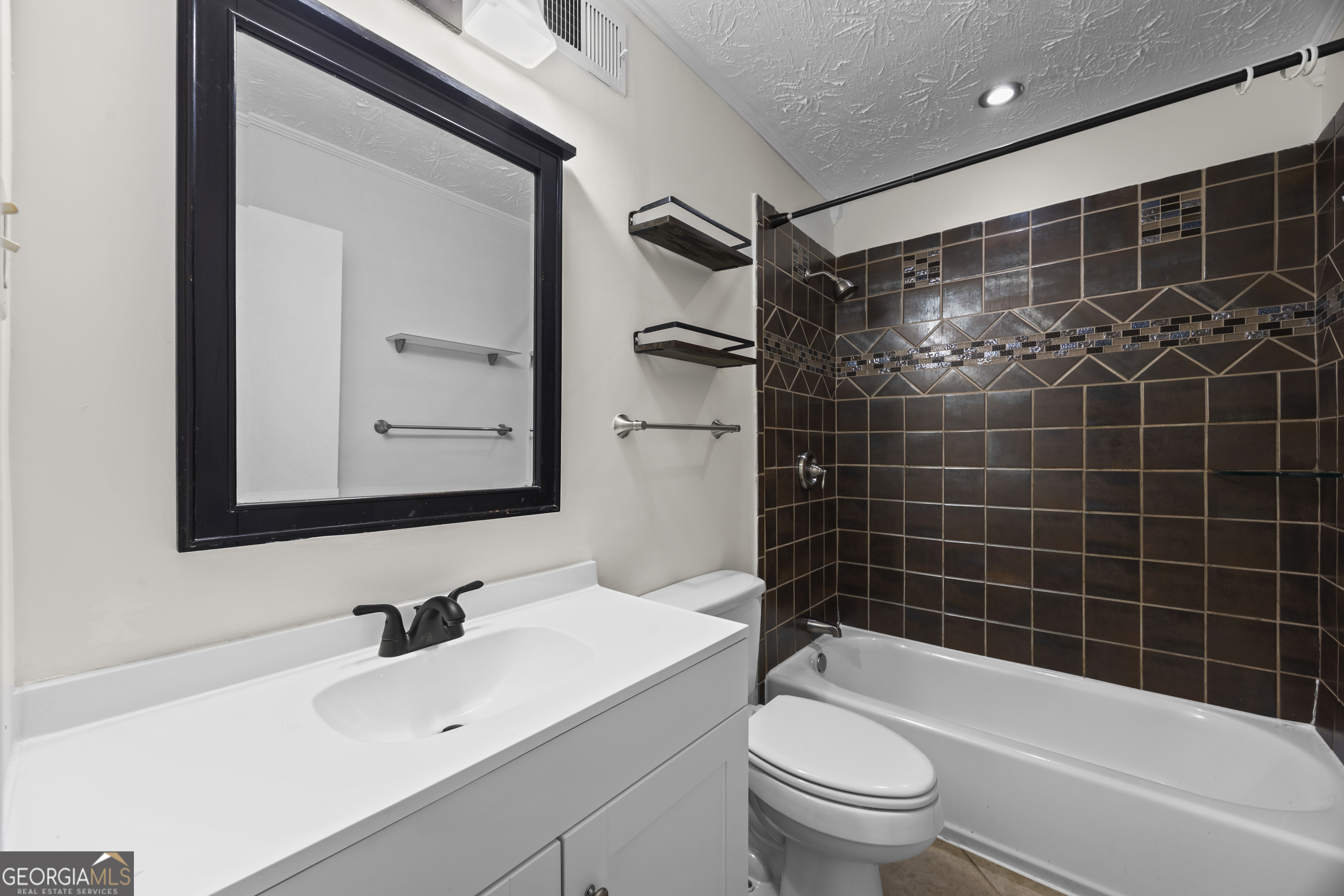 135 Hill Street, Unit 22 Decatur, GA 30030 - Photo 16 of 36 a bathroom with a bathtub shower sink vanity and toilet