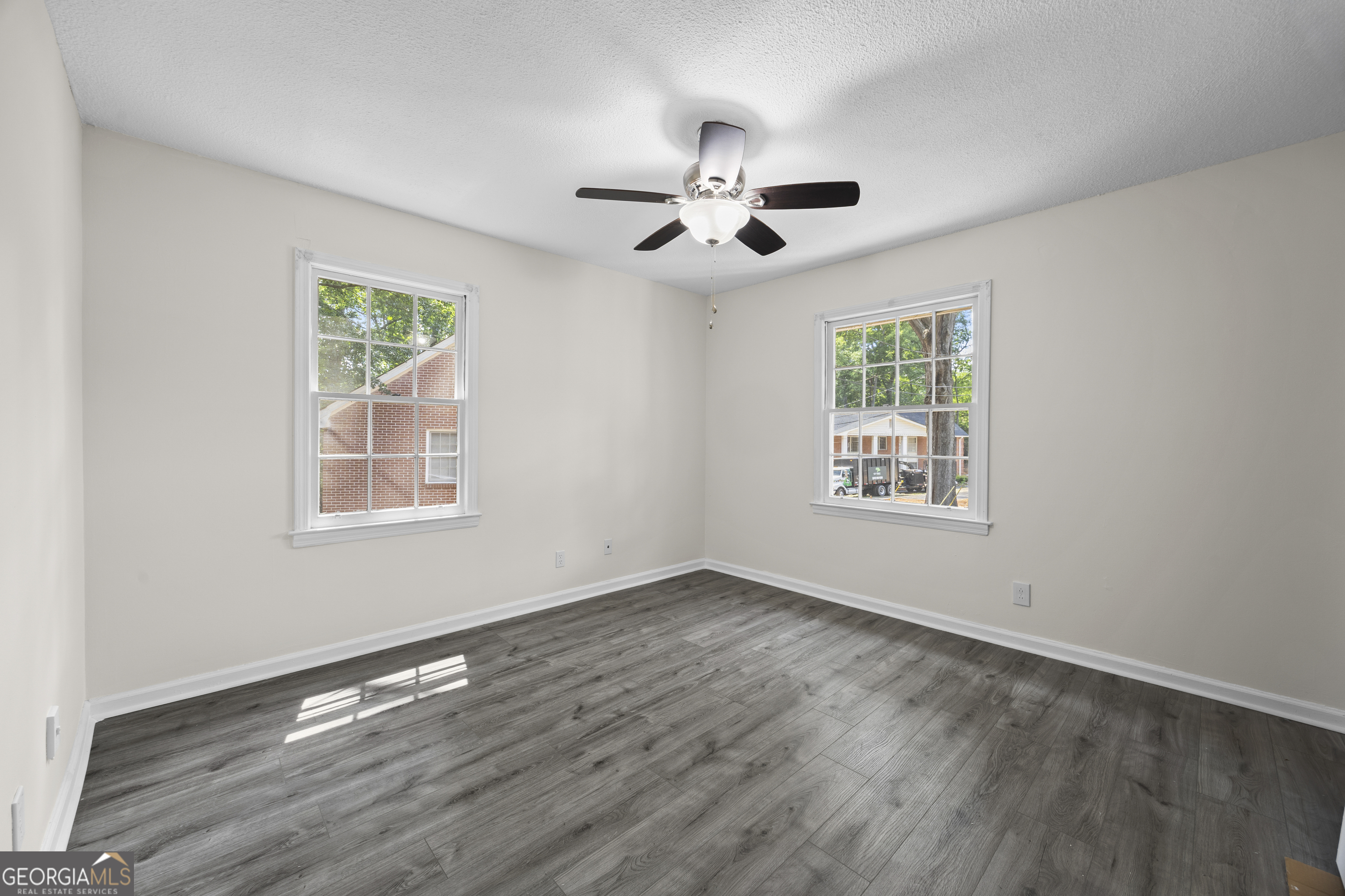 135 Hill Street, Unit 22 Decatur, GA 30030 - Photo 19 of 36 a view of an empty room with wooden floor and a window