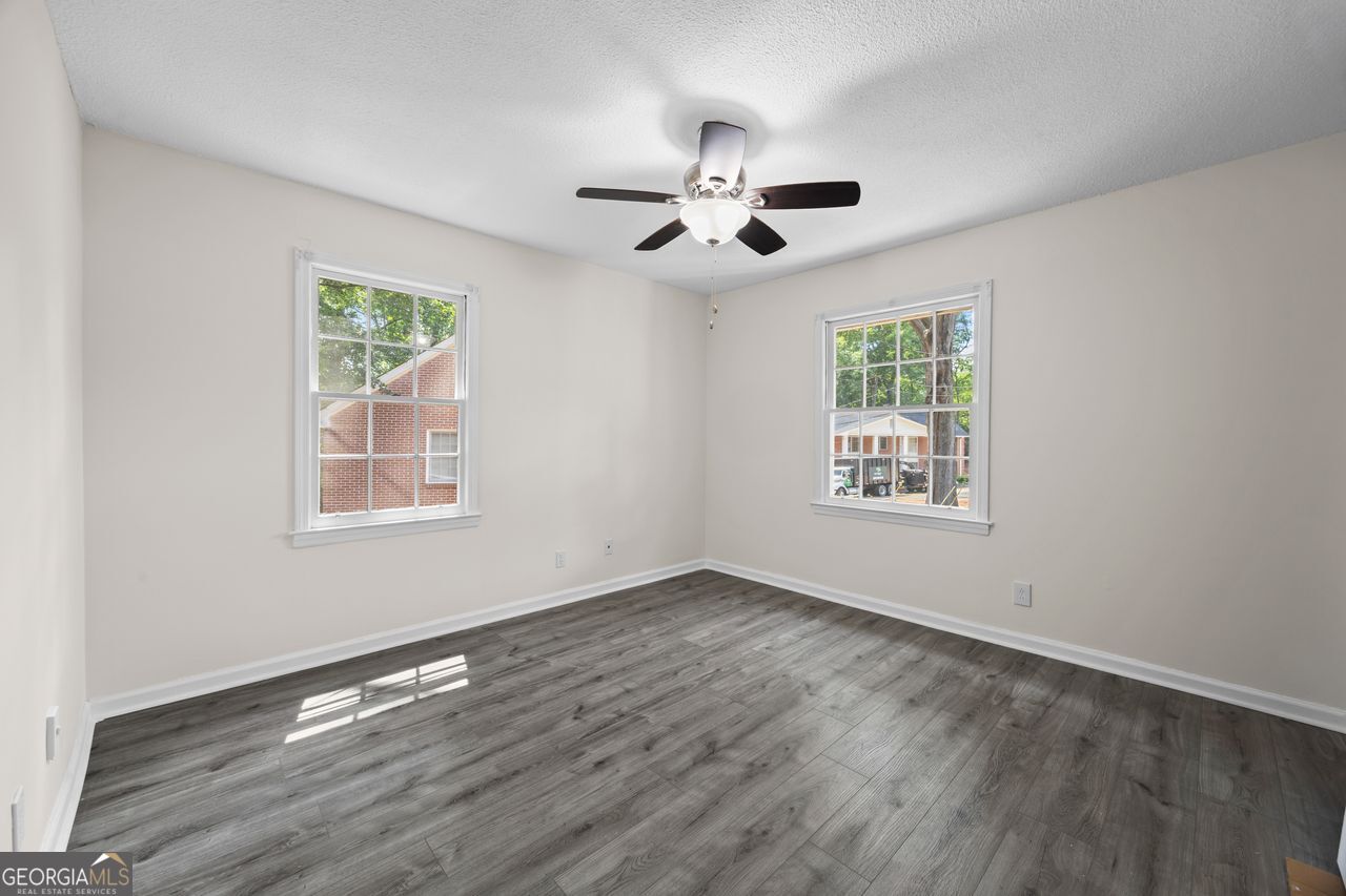 135 Hill Street, Unit 22 Decatur, GA 30030 - Photo 36 of 36 a view of an empty room with wooden floor and a window