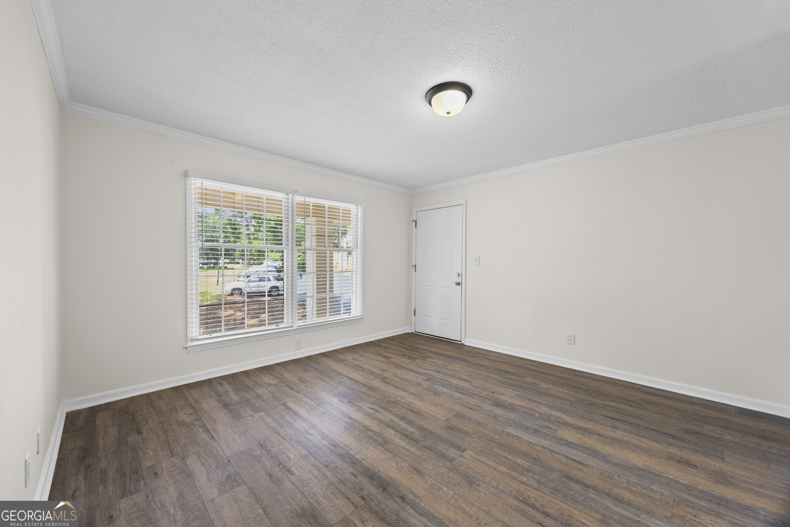 135 Hill Street, Unit 22 Decatur, GA 30030 - Photo 8 of 36 an empty room with wooden floor and windows