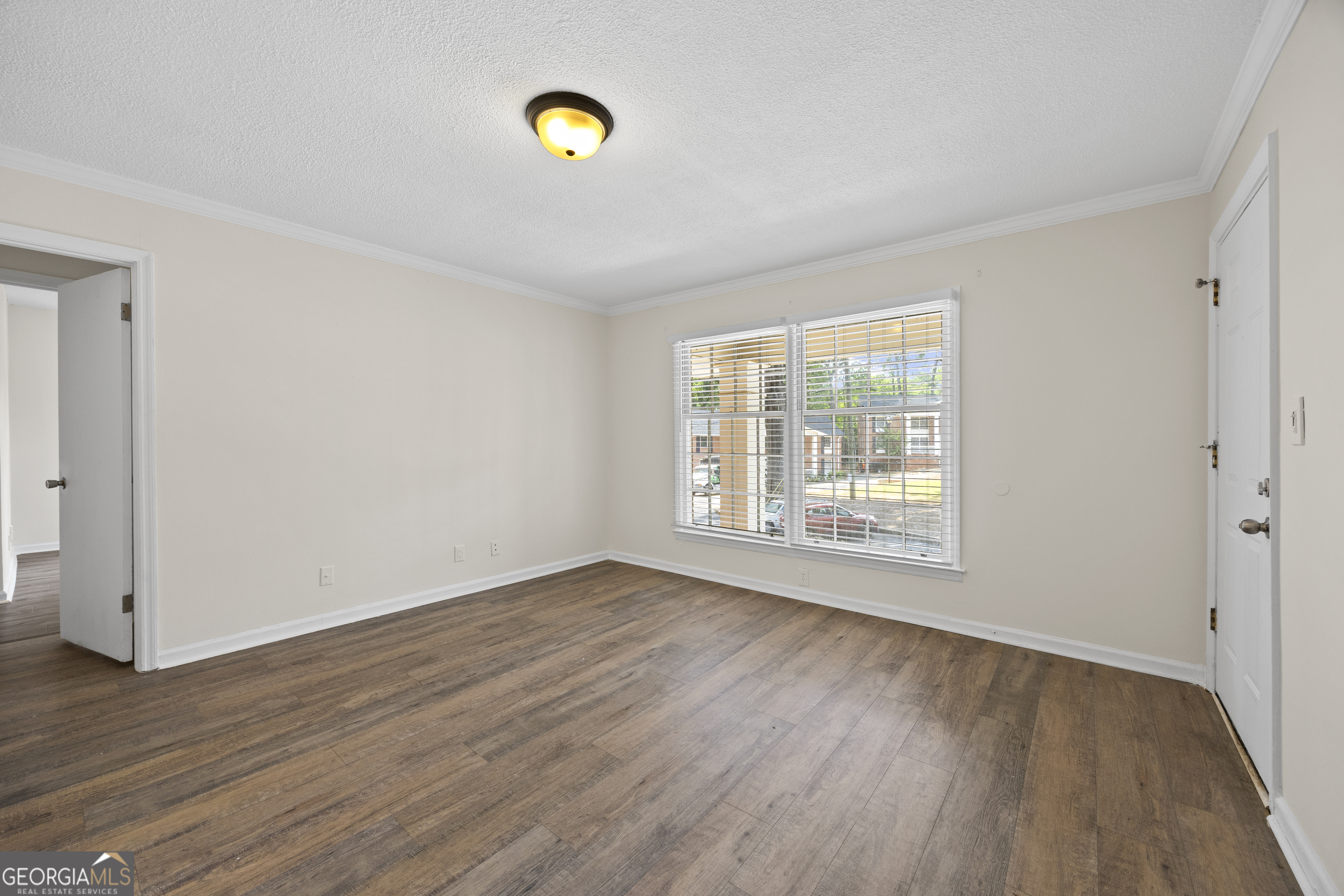 135 Hill Street, Unit 22 Decatur, GA 30030 - Photo 9 of 36 an empty room with wooden floor and windows
