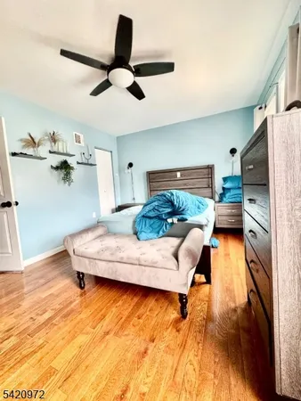 a bathroom with a tub and view of living room