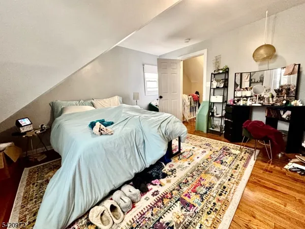 a bedroom with bed and flat screen tv