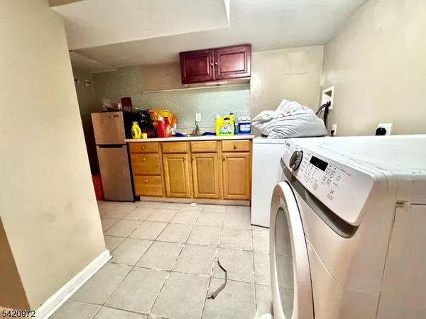 a view of a hallway with wooden floor and a potted plant