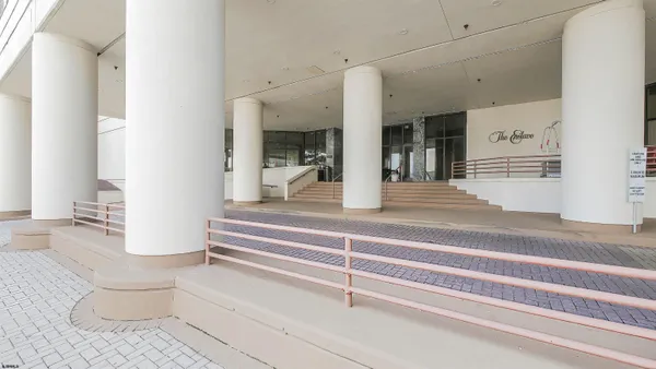 a kitchen with stainless steel appliances kitchen island granite countertop a refrigerator and a stove top oven