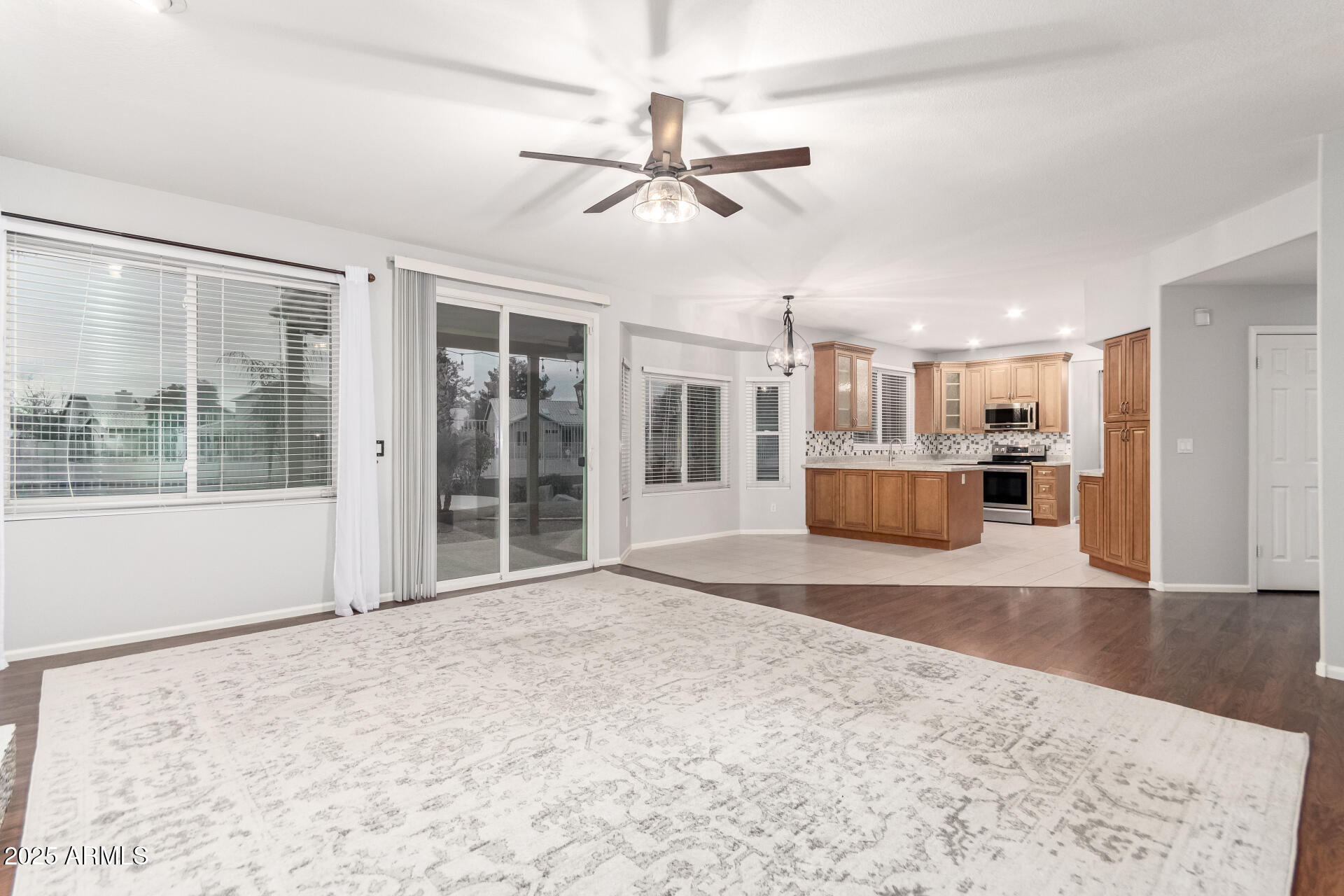 518 South Pueblo Street Gilbert, AZ 85233 - Photo 13 of 50 a view of an empty room with a window and wooden floor
