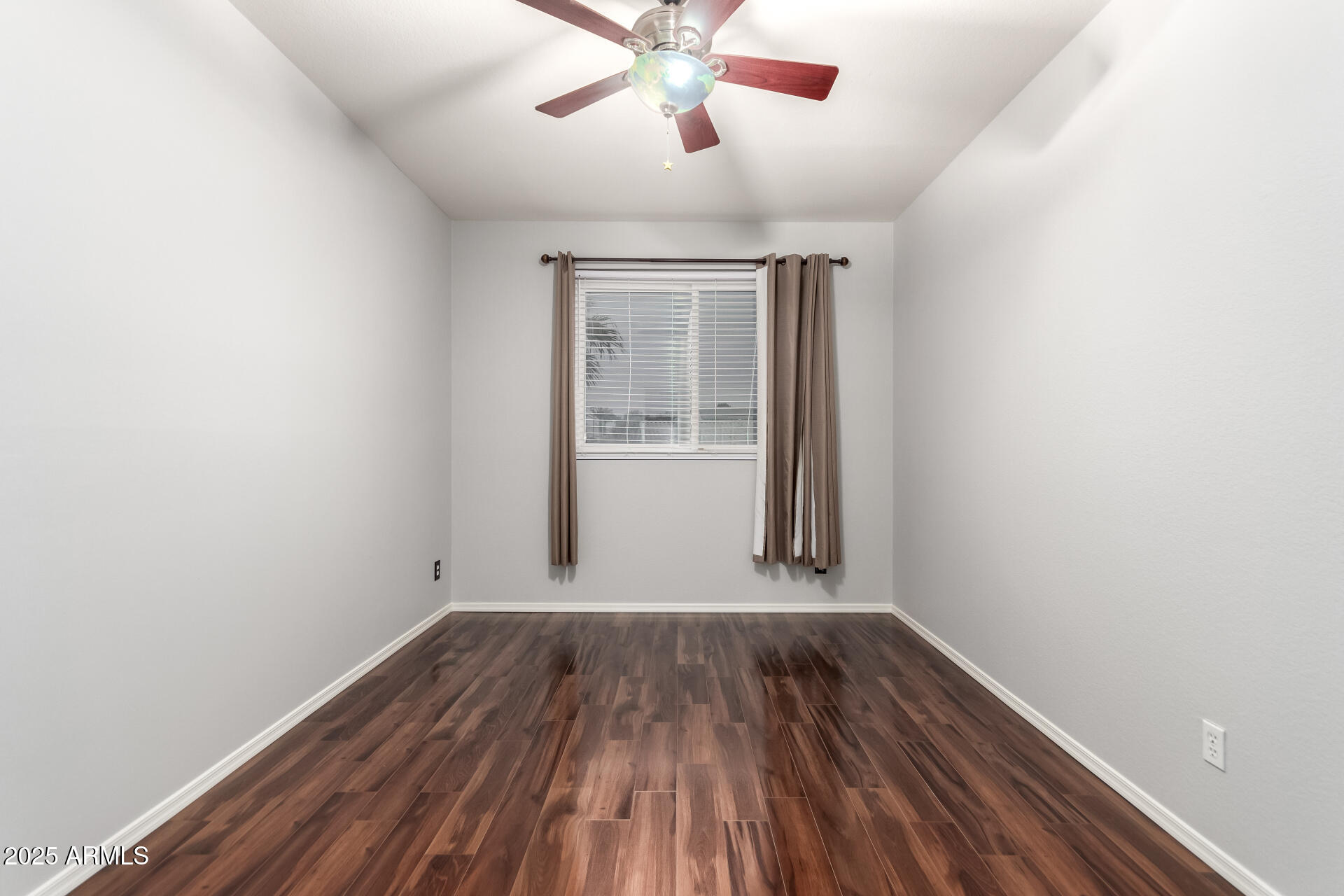 518 South Pueblo Street Gilbert, AZ 85233 - Photo 34 of 50 an empty room with wooden floor chandelier fan and windows