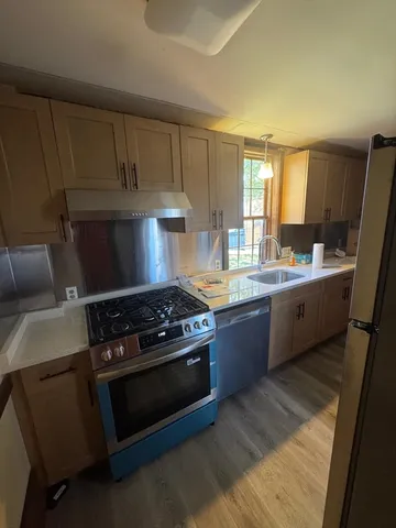 a kitchen with a stove and a sink