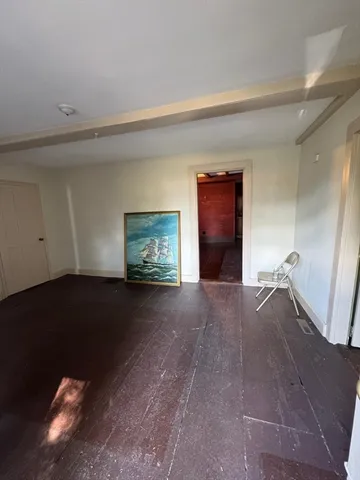 a view of a livingroom with an empty space and a window