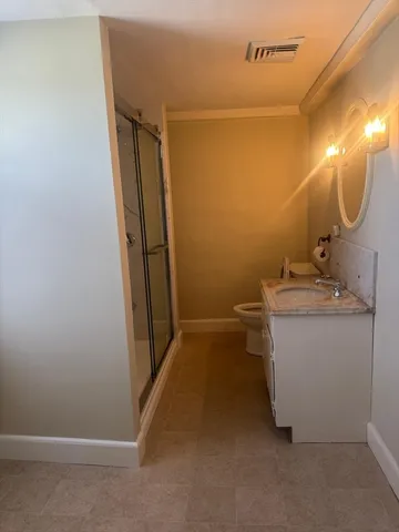 a bathroom with a sink toilet and shower