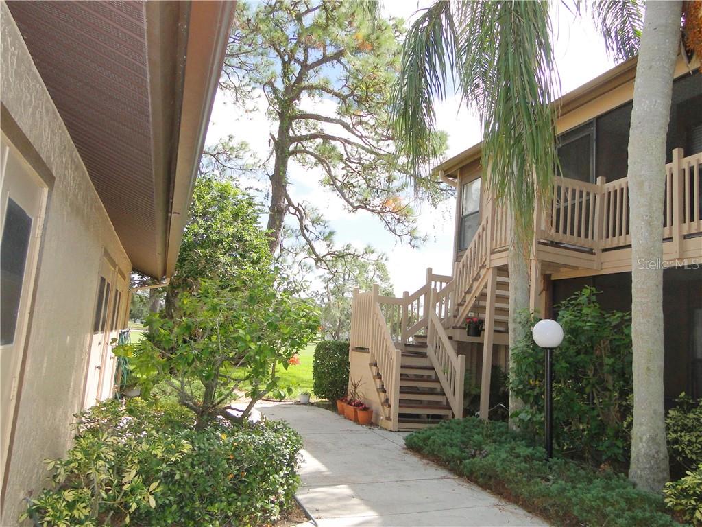 5753 Avista Drive Sarasota, FL 34243 - Photo 1 of 32 a front view of a house with a garden