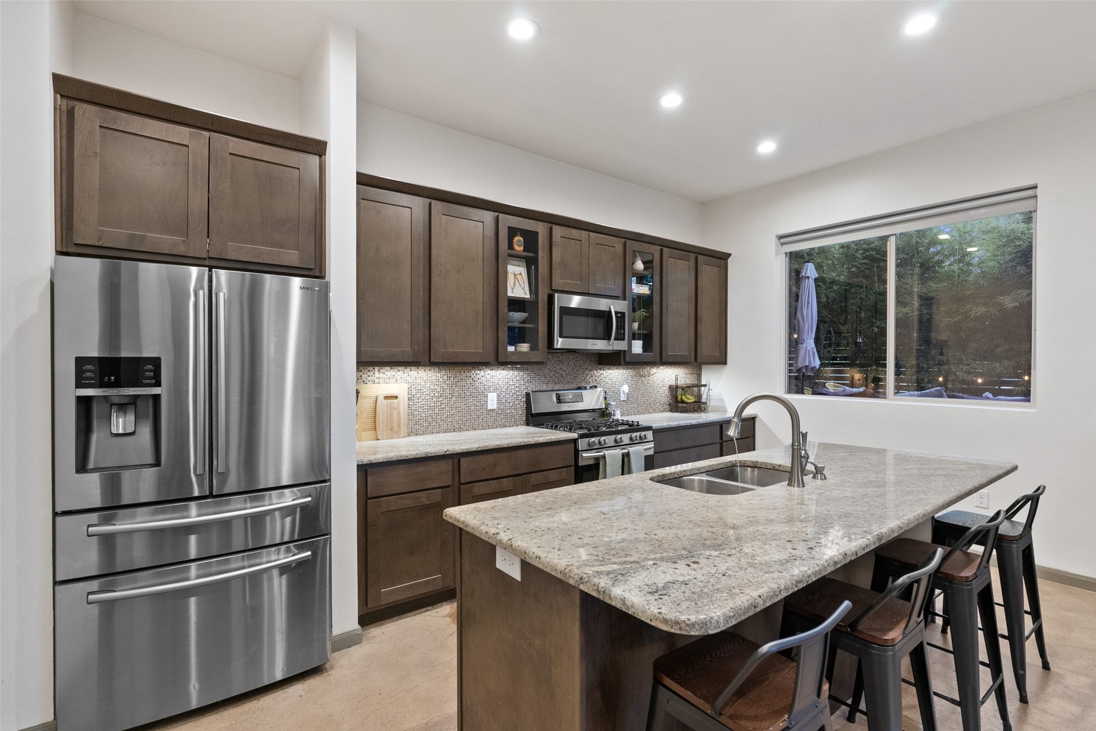 1158 Ridgeway Drive, Unit A Austin, TX 78702 - Photo 8 of 28 Culinary dreams come alive in this kitchen featuring abundant cabinetry and a spacious granite island.