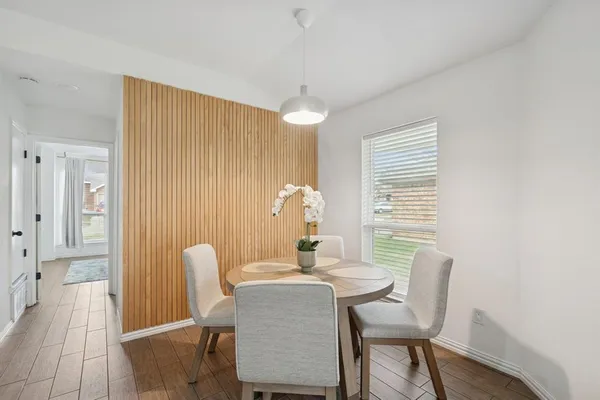 a dining room with furniture and window