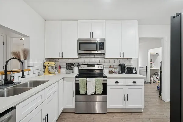 a kitchen with stainless steel appliances granite countertop a stove and a sink