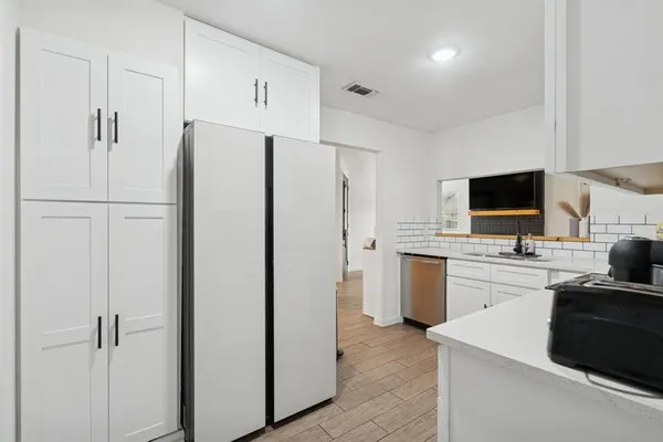 a kitchen with a refrigerator stove and sink