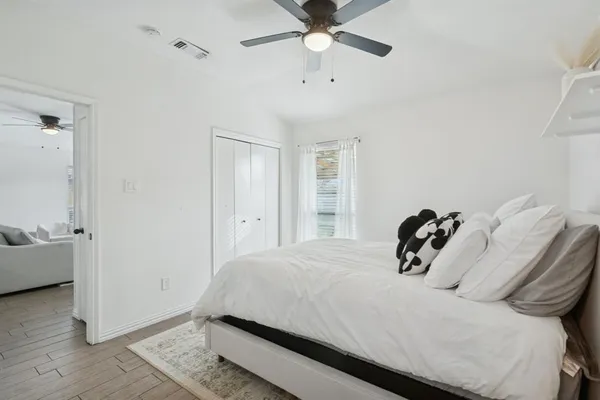a bedroom with a bed and a chandelier