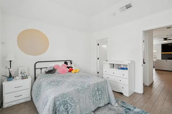 a bedroom with a bed and a dresser