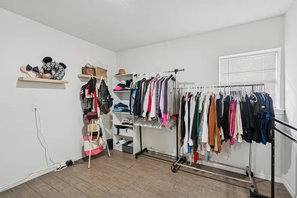a view of walk in closet with clothes
