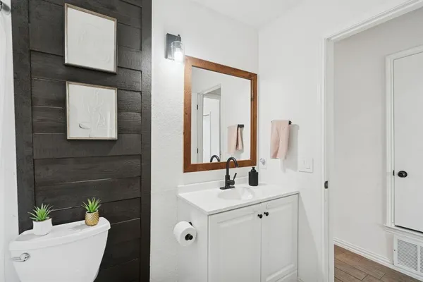a bathroom with a toilet sink and mirror
